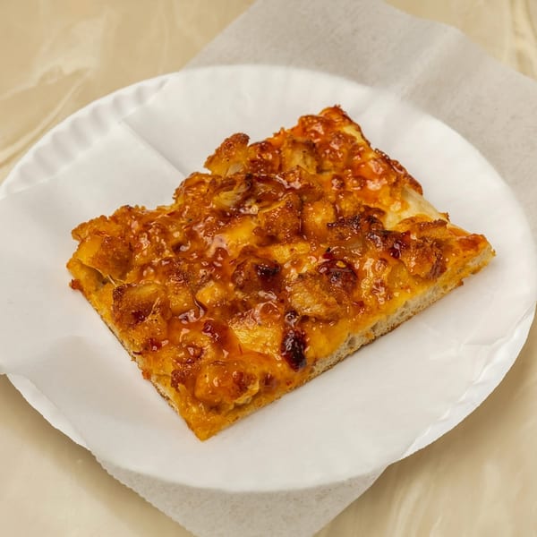 A slice of Tori T's Pizzeria's chicken pizza with a sweet and spicy glaze.